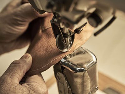 Leather-repair-perth man stitching leather